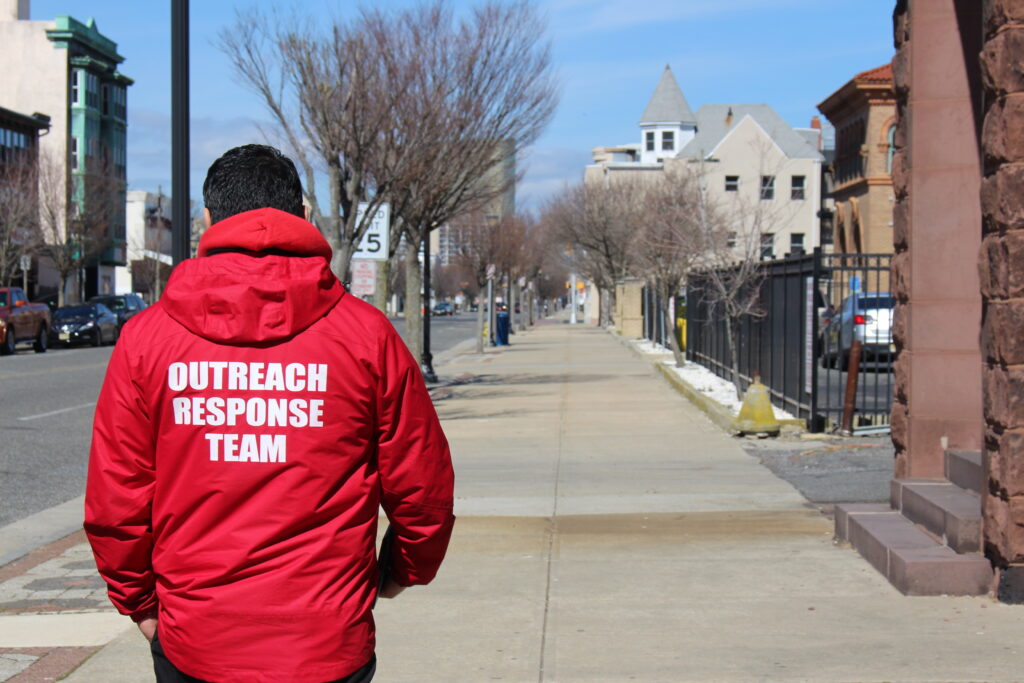 A VOADV staff member wearing a jacket with "Outreach Response Team" written on the back.